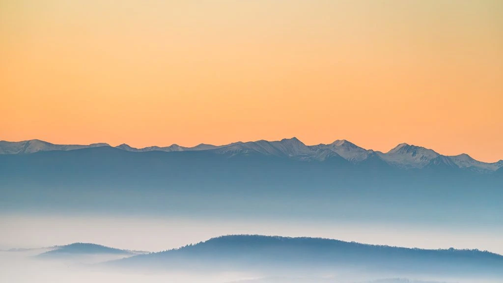 A misty alpine ridge at first light, representative of the Nature mood