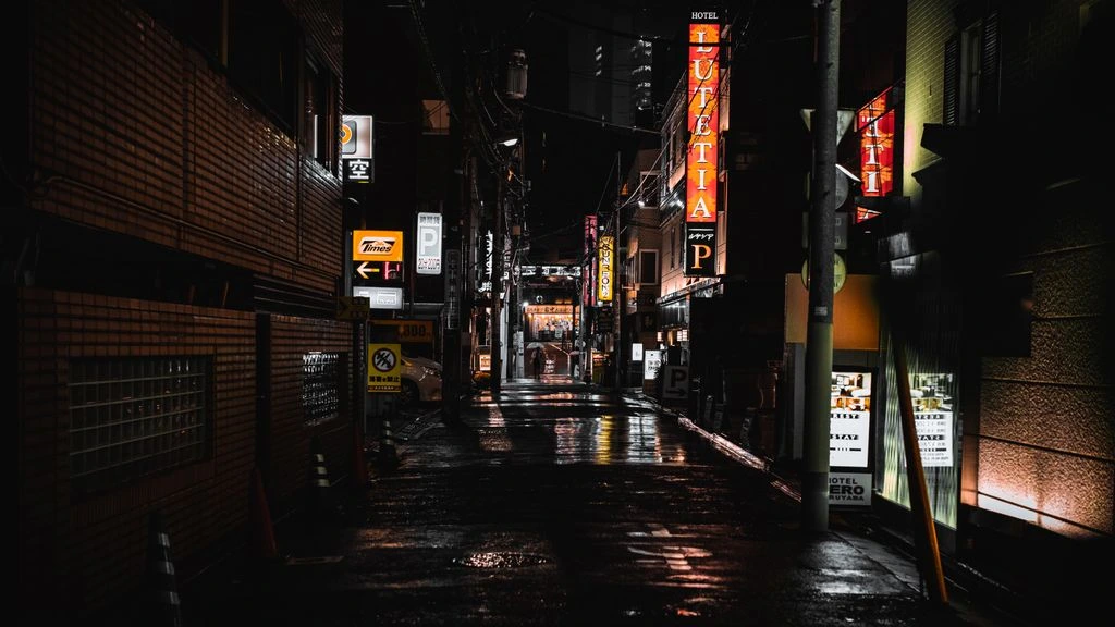 A rain-soaked Tokyo backstreet at night, washed in magenta and cyan neon.